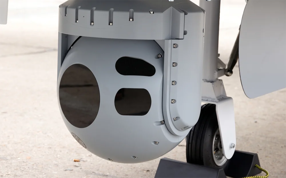 Helicopter-mounted stabilized electro-optical gimbal system for surveillance and targeting.